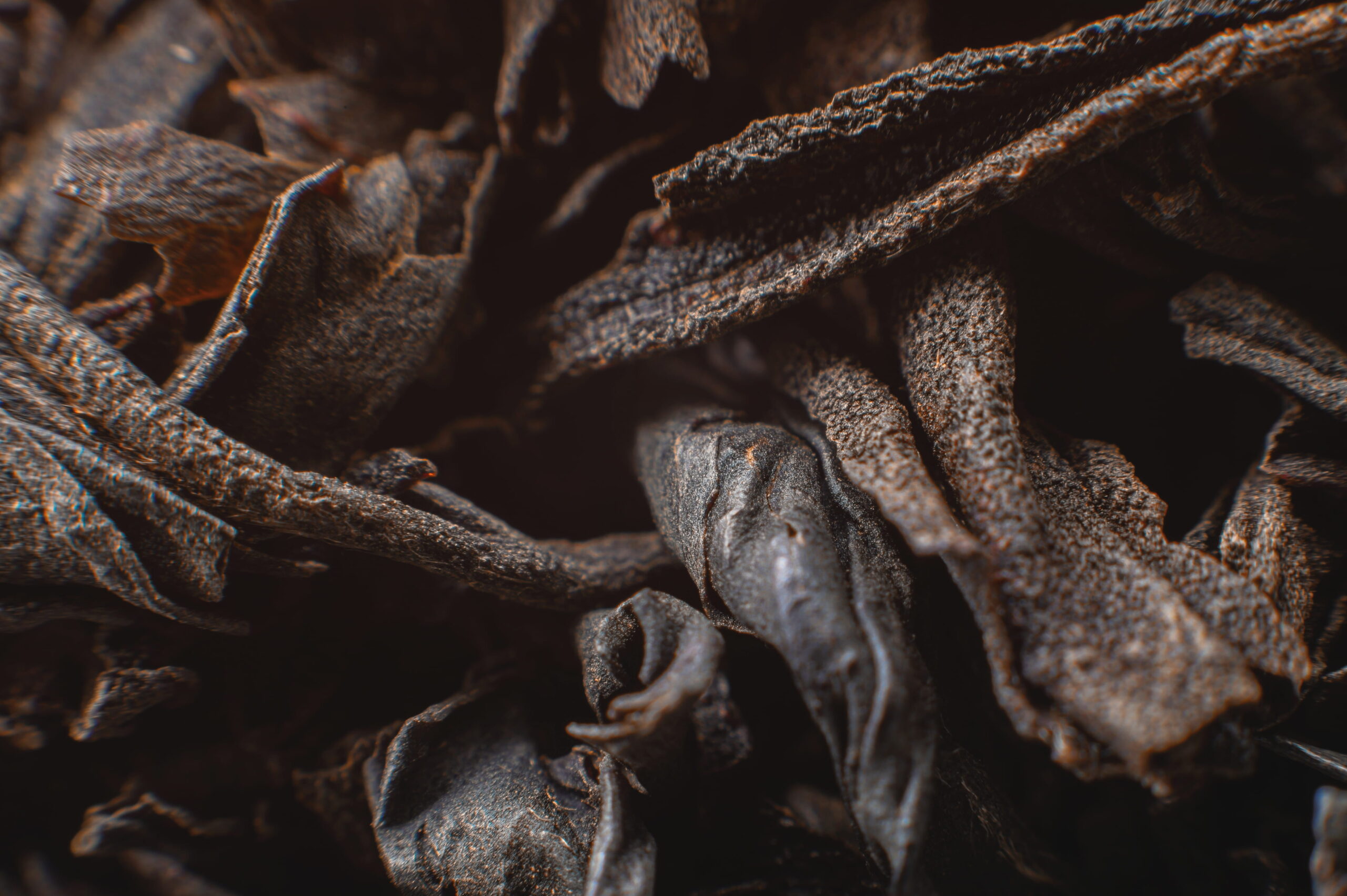 black-loose-leaf-tea-as-background-texture-dry-black-tea-leaves-dark-background-extreme (1)